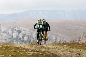 zwei männliche Radfahrer fahren Mountainbike in einer Bergregion, reisen Radfahren